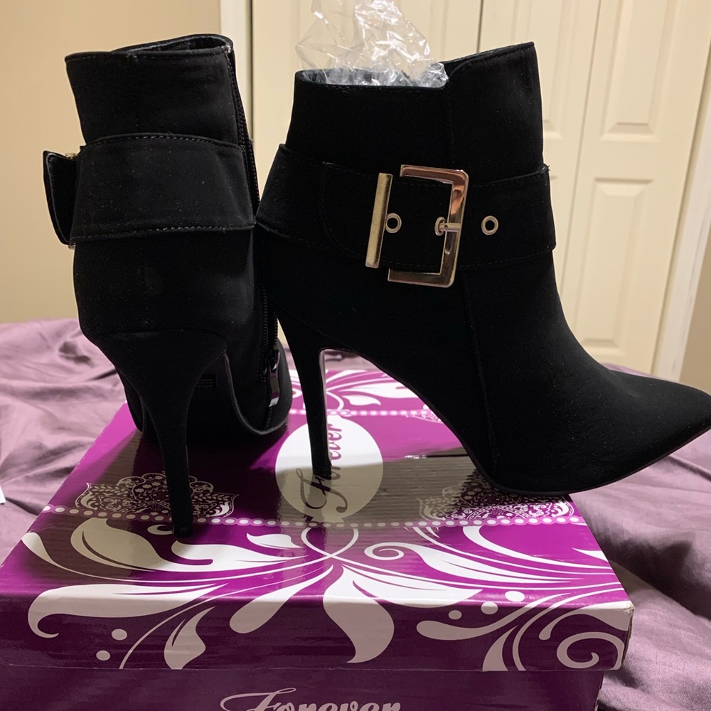 Black pointed toe booties with silver buckle